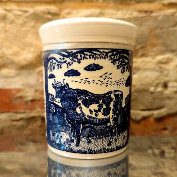 Detail of the illustration on a ceramic Stilton pot, featuring a cow and rabbit standing in a pasture.