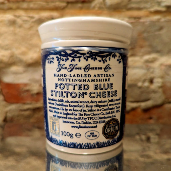 Detail of the back of a ceramic Stilton pot, with the ingredients and origin information.