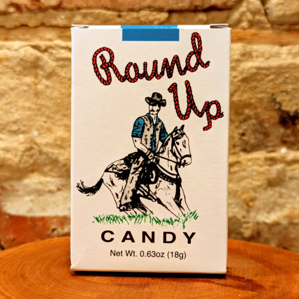 A single, white box of Round Up-branded candy cigarettes with an illustration cowboy on the front.