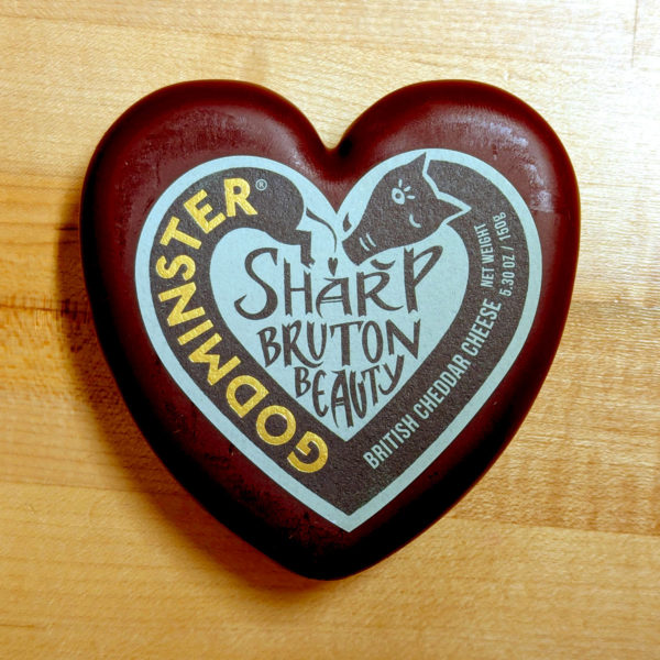 A heart-shaped Sharp Bruton Beauty cheese in burgundy wax.