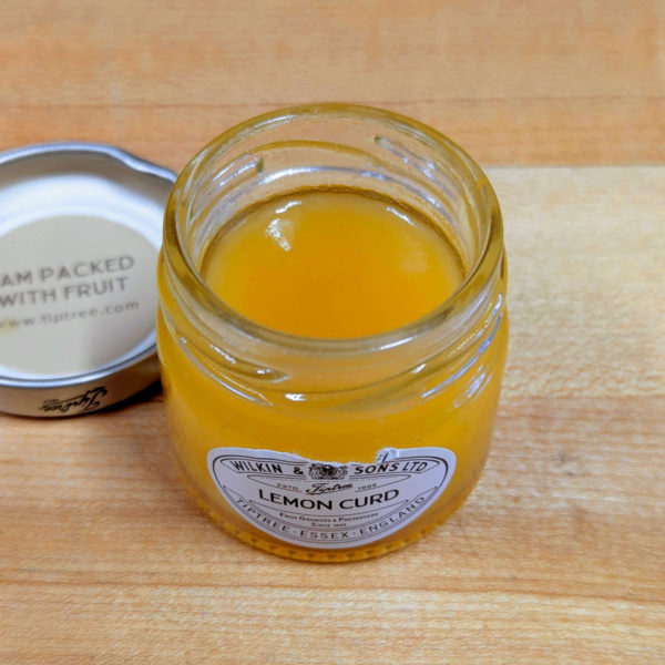 An open jar of lemon curd.