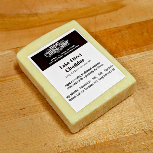 A wrapped block of Lake Effect Cheddar cheese.