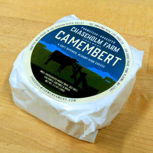 An alternate angle of Chaseholm Farm Camembert, in its wrapper.