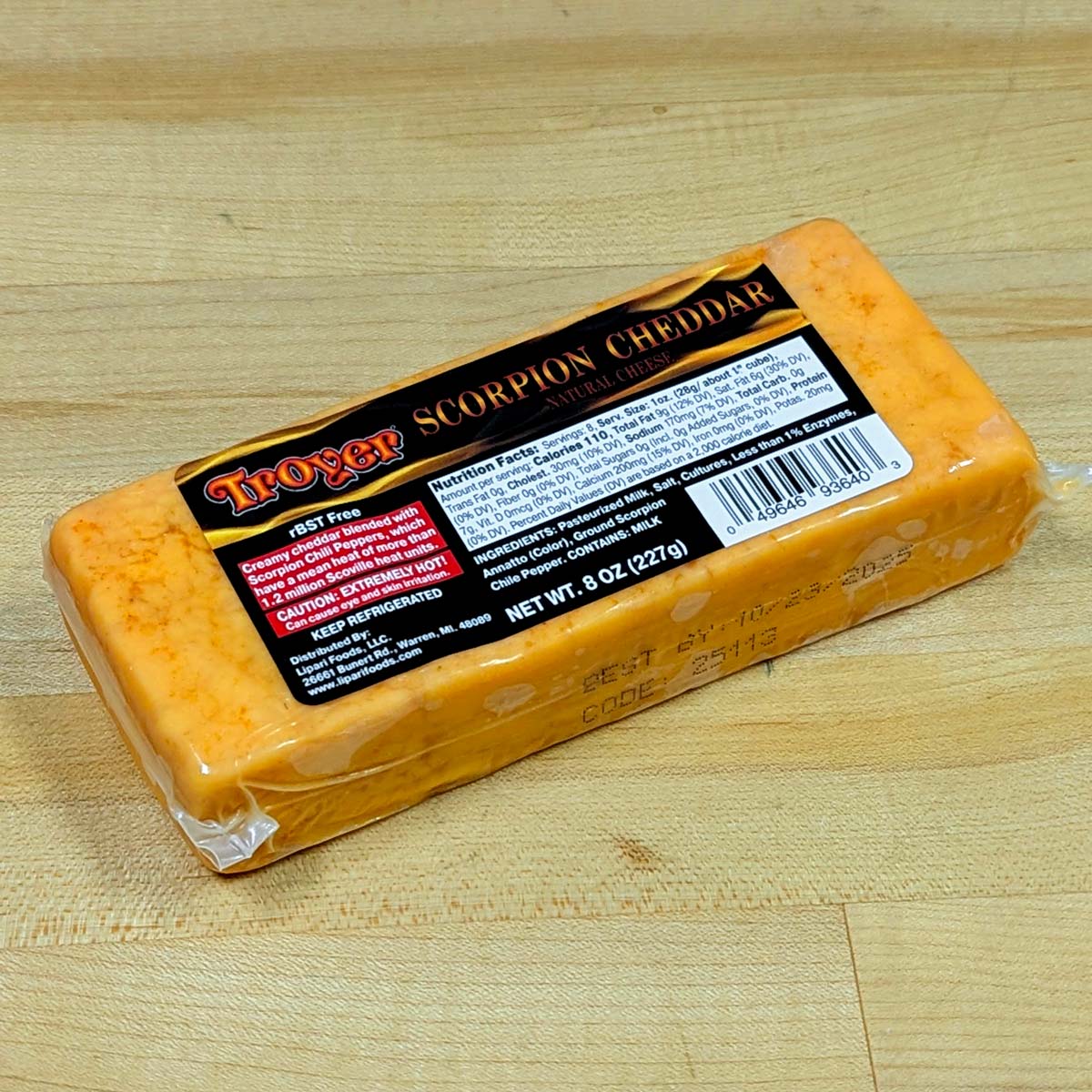An alternate angle of a block of Scorpion Cheddar, in its packaging.