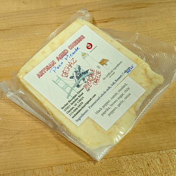 Low angle of a wedge of Poco Picante brick cheese.