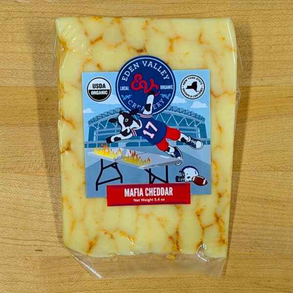 A wedge of Mafia Cheddar cheese.
