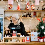 Festive Cafe Scene with Elderly Woman at Counter