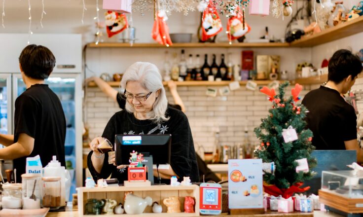 Festive Cafe Scene with Elderly Woman at Counter