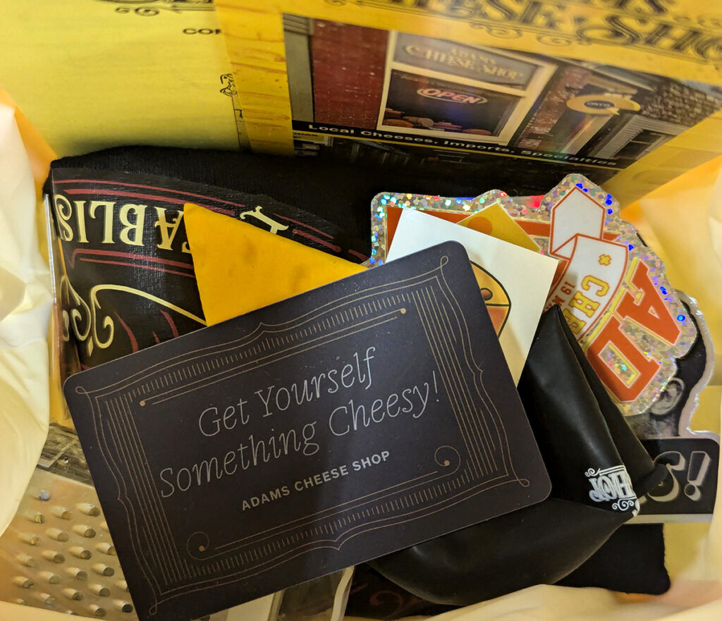 A raffle for a tote bag full of merch and an Adams Cheese Shop gift card.