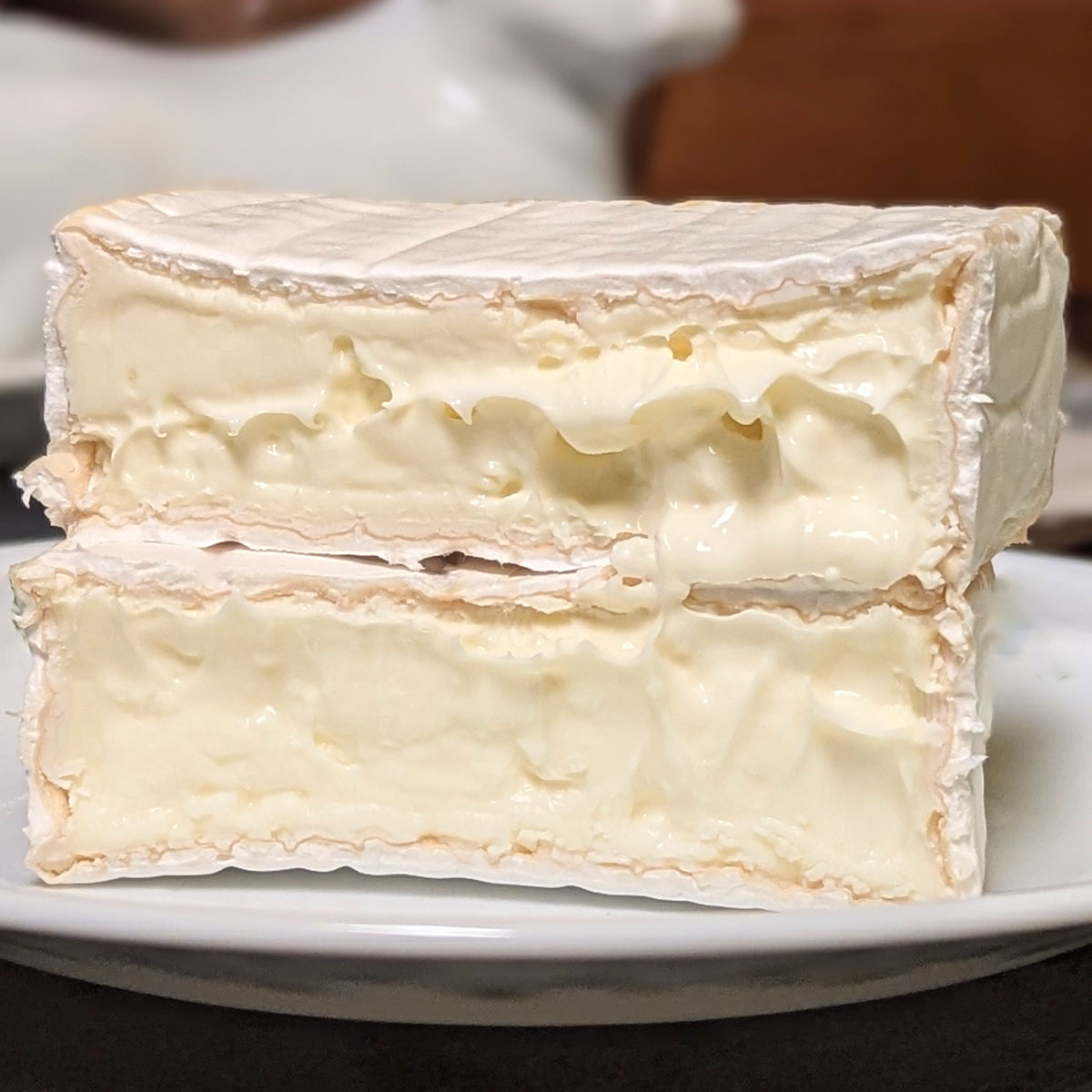 A block of Hudson Valley Camembert, cut down the middle.
