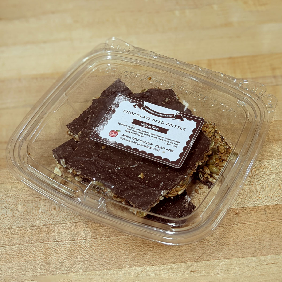 A container of chocolate seed brittle.